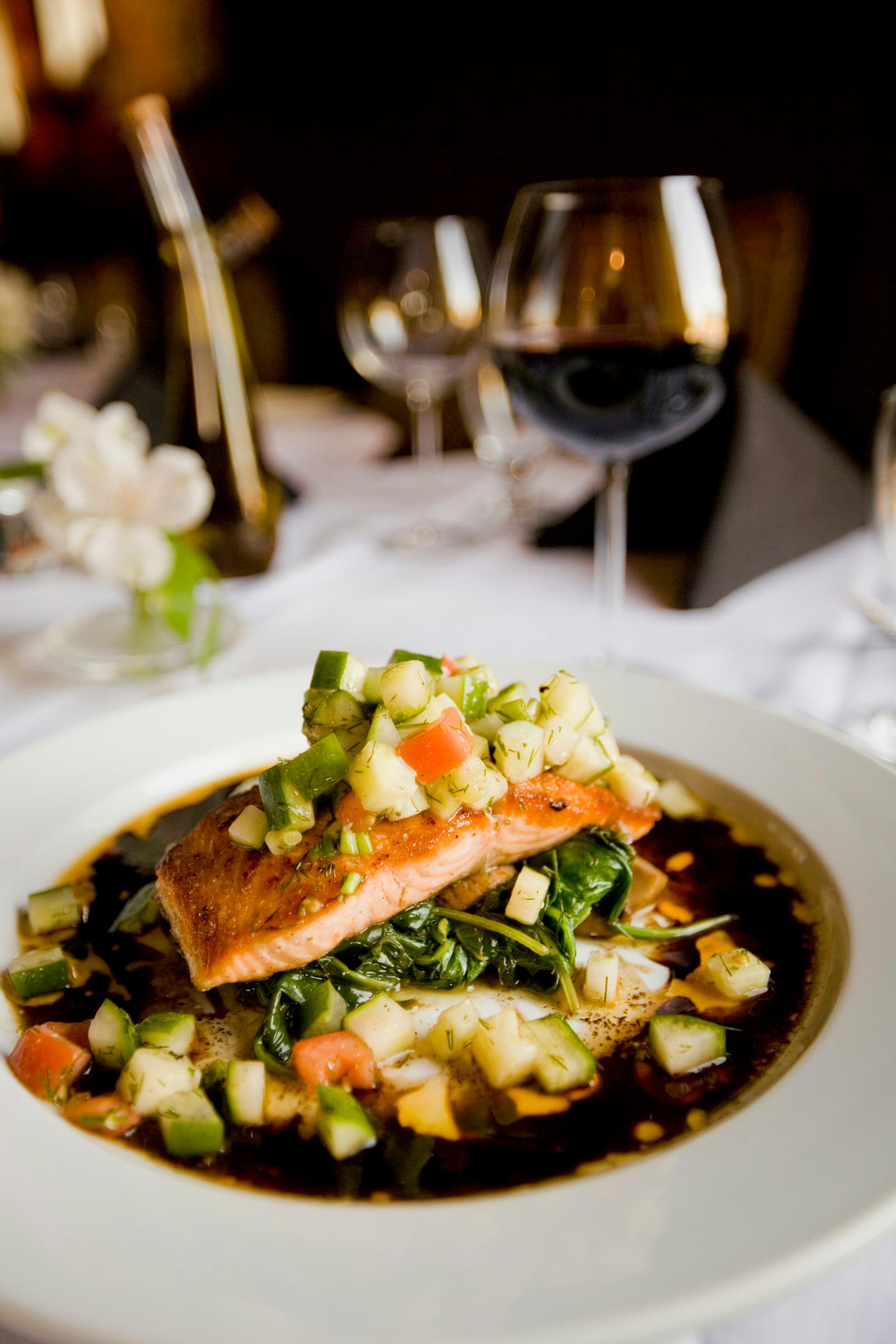 A composed plate of salmon on white linen