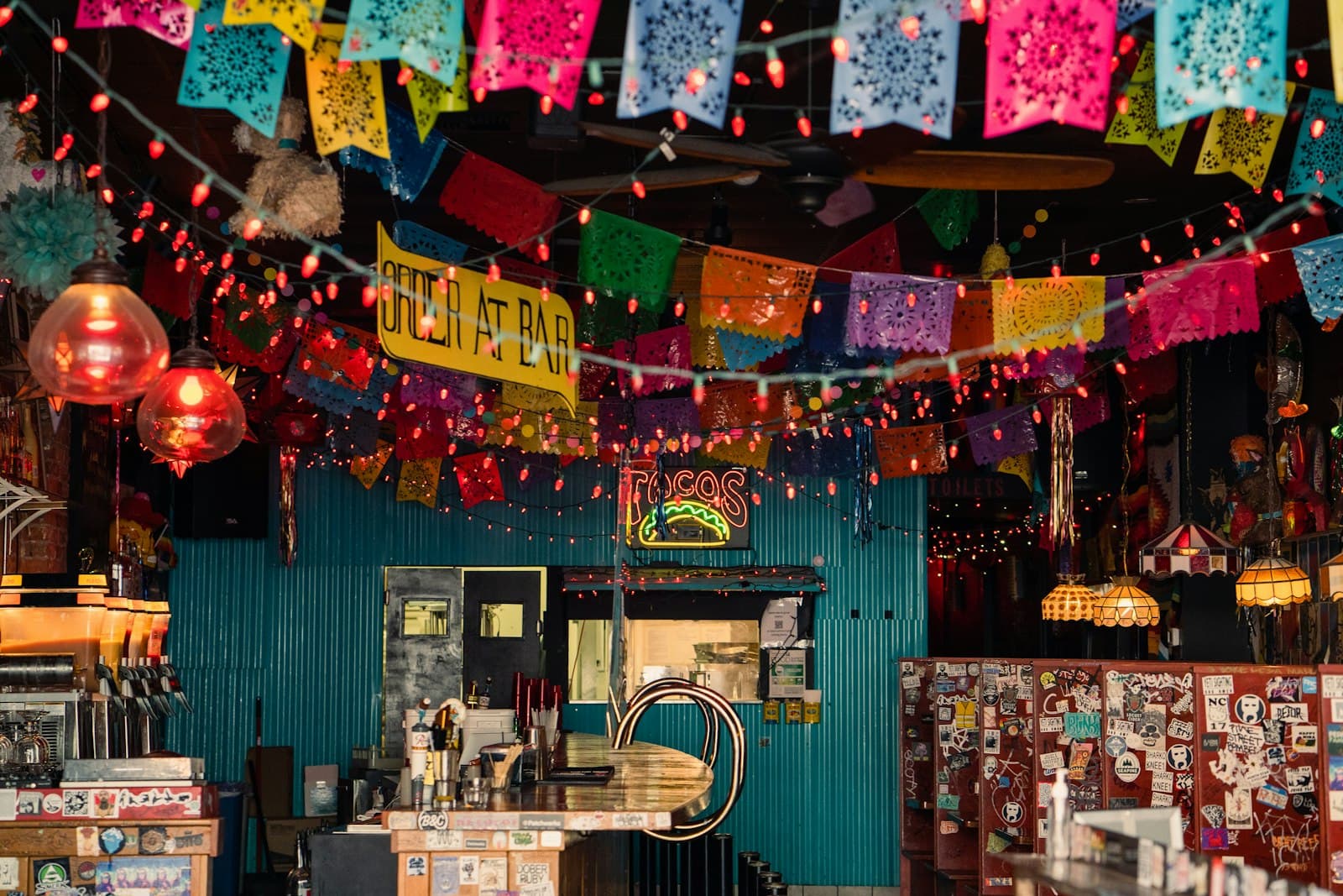 Papel picado and warm lights over an Oaxacan bar