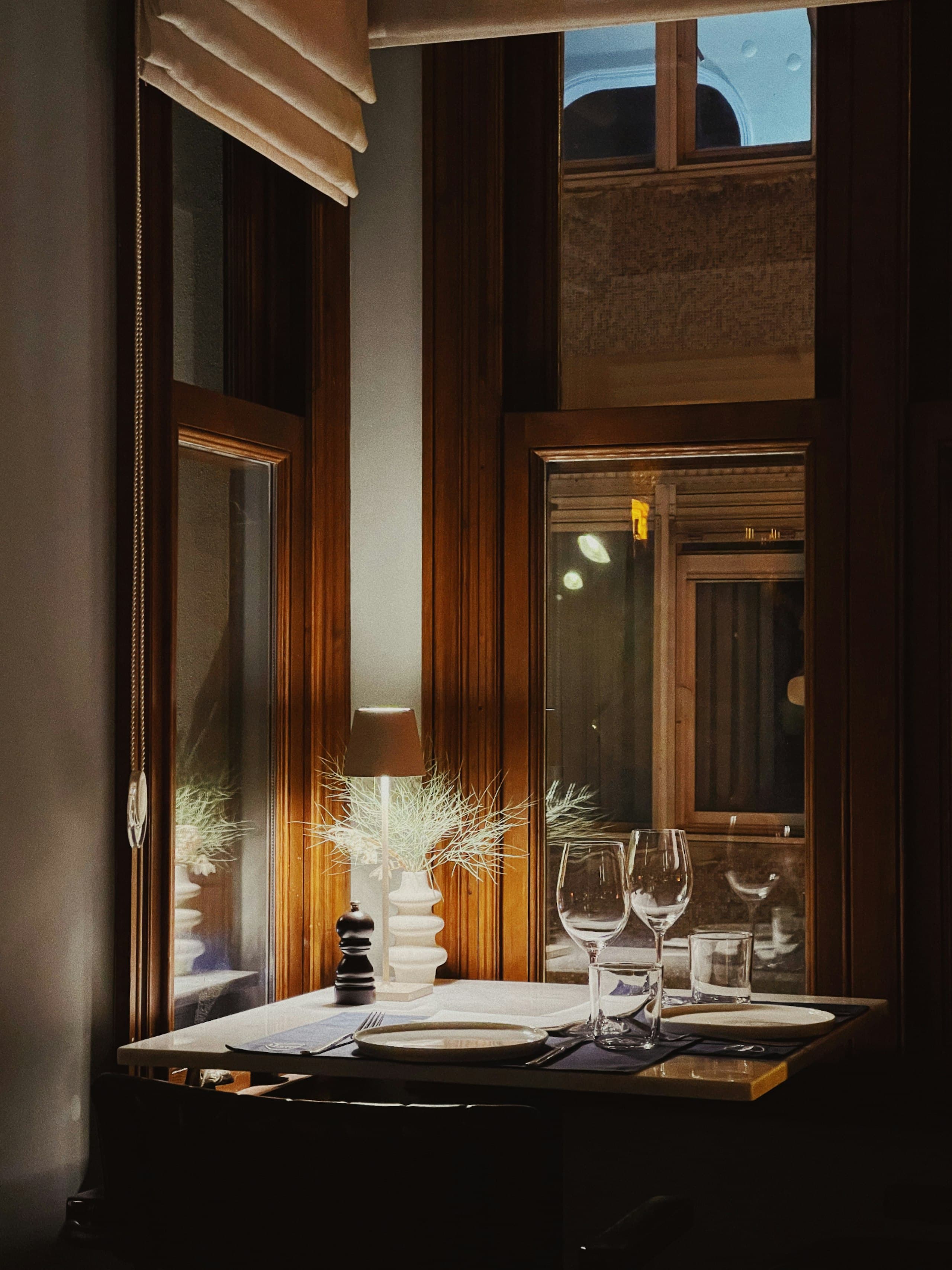 A lamplit corner table in the Paris dining room